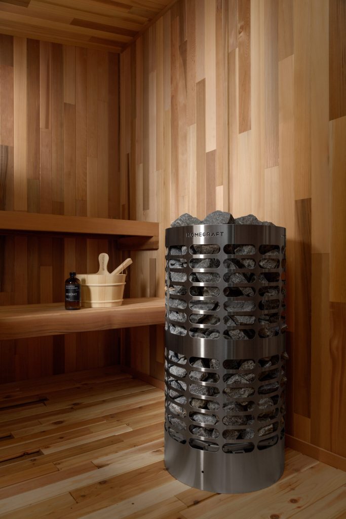 Apex heater in a finished cedar sauna Homecraft Apex sauna heater in a cedar corner with benches, wall light, bucket and ladle