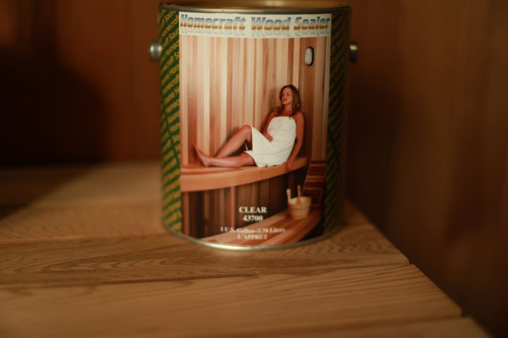 Homecraft Wood Sealer sauna sealant in one-gallon and one-quart tins on cedar