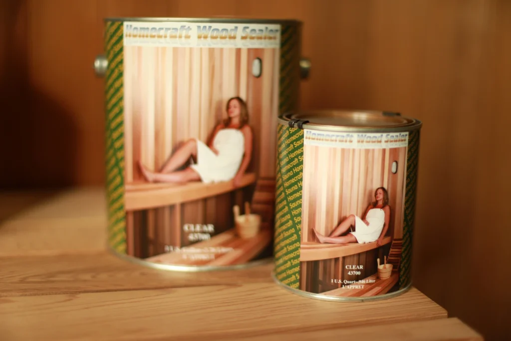 Large and small Homecraft Wood Sealer sauna sealant tins displayed on a cedar shelf