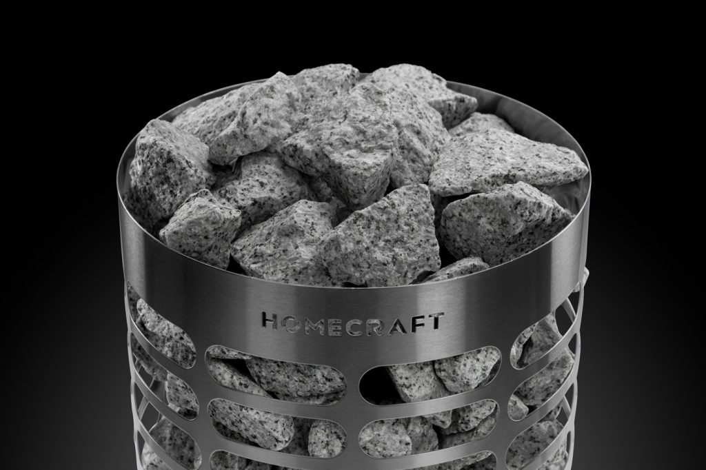 Pale grey sauna stones packed into a Homecraft Apex Mini heater above the branded steel band