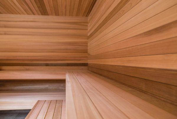 Clear western red cedar sauna corner with natural grain and colour across walls, ceiling and bench